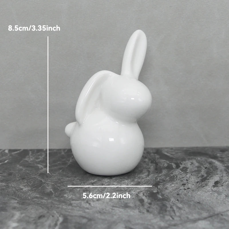 White ceramic bunny figurine with measurements on a gray background