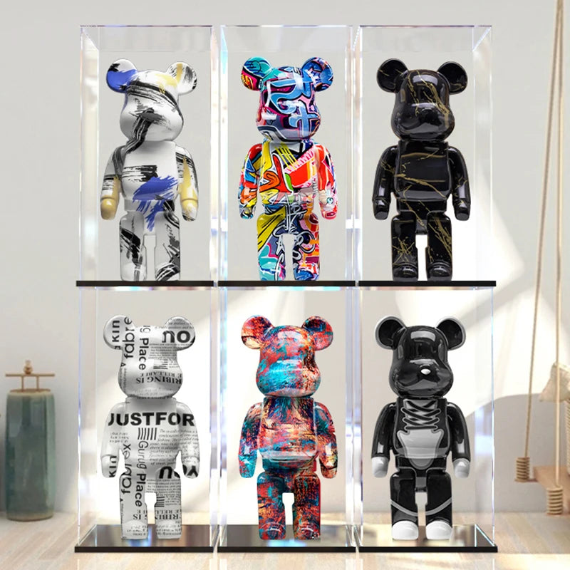 Six colorful bear figurines in a glass display case.