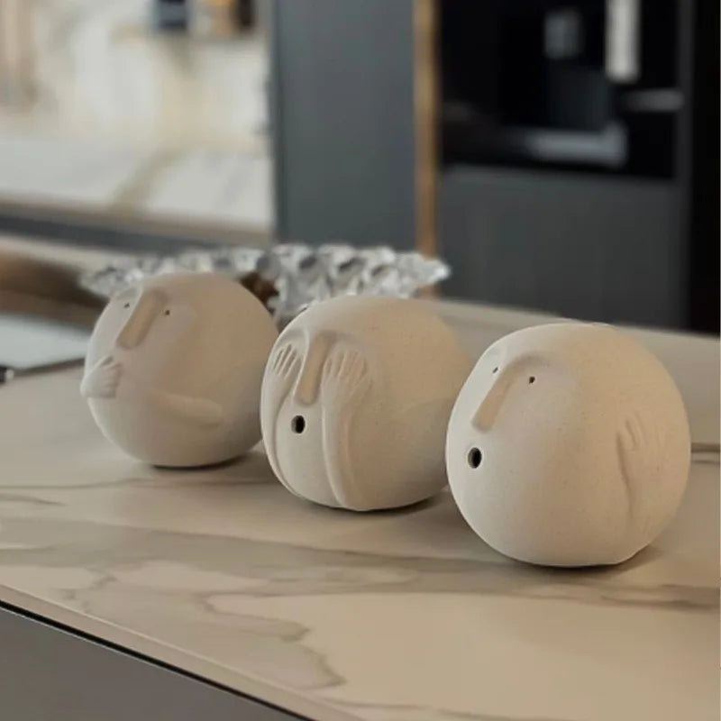 Abstract white ceramic face ornament styled on modern coffee table in minimalist interior