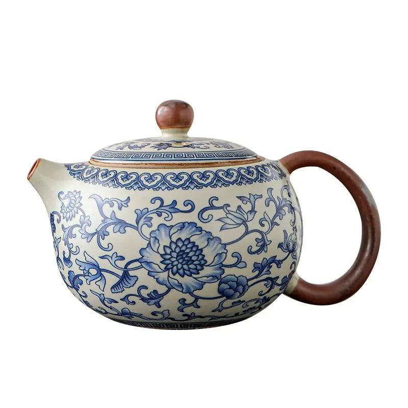 Ceramic teapot with blue floral patterns on a white background