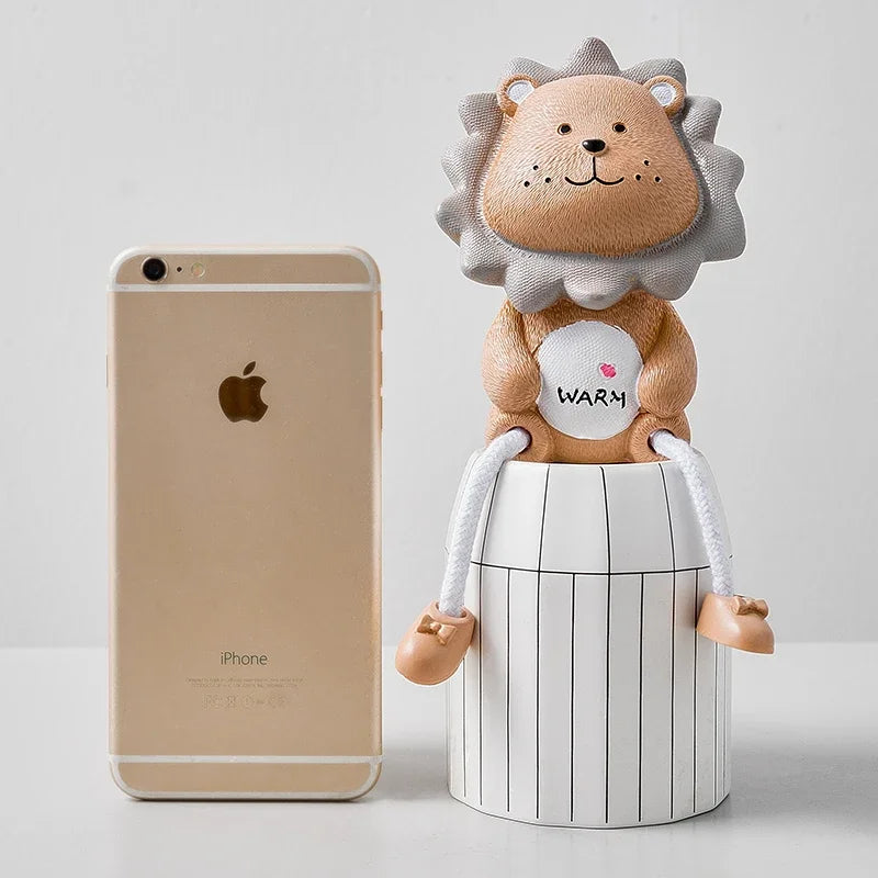 Lion-shaped container with a phone for scale on a light background
