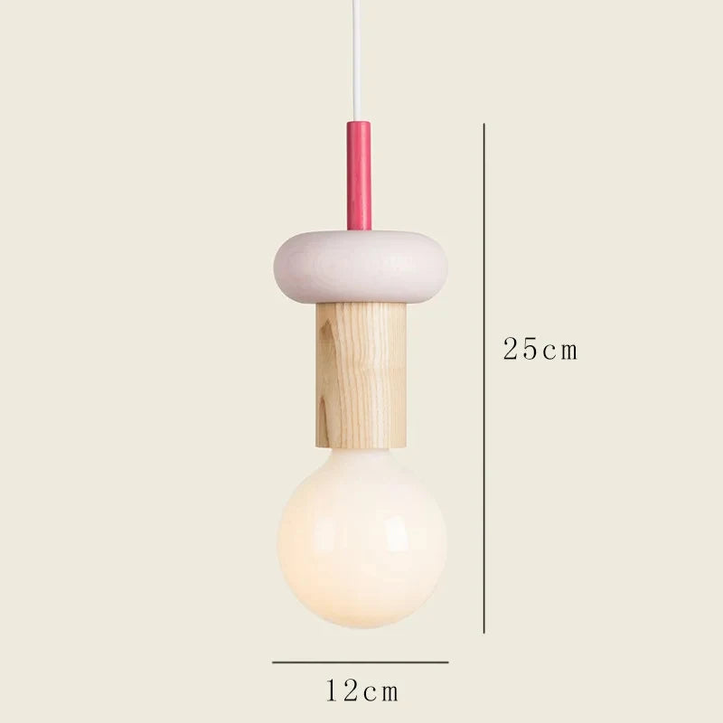 Small pendant light with wooden base and pink top on a beige background