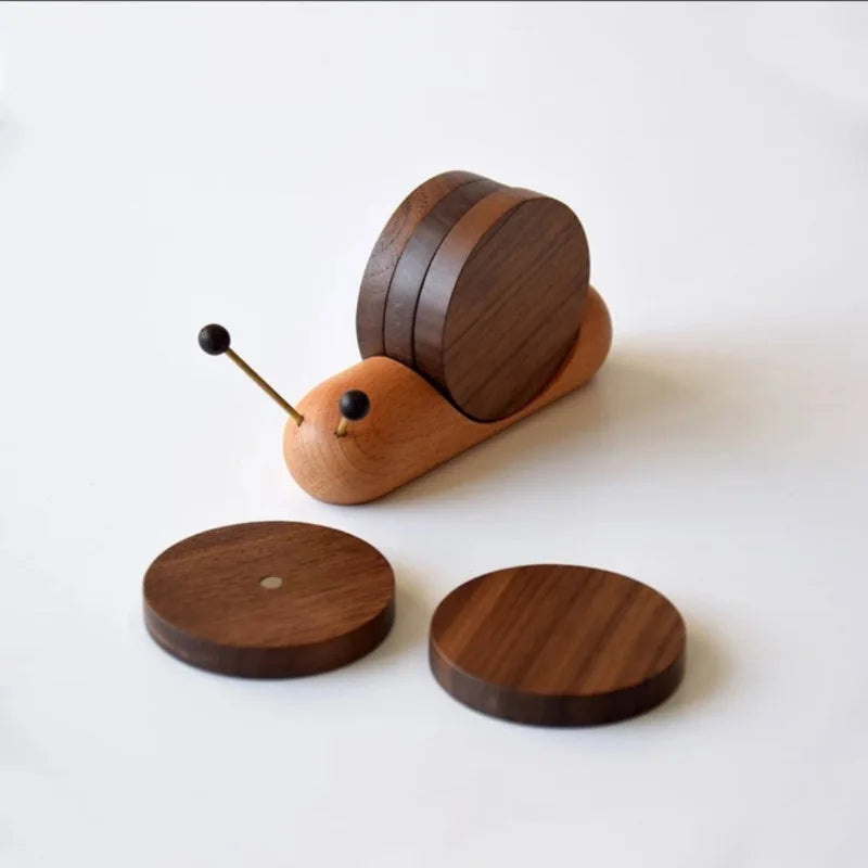 Wooden snail coaster set on a white background