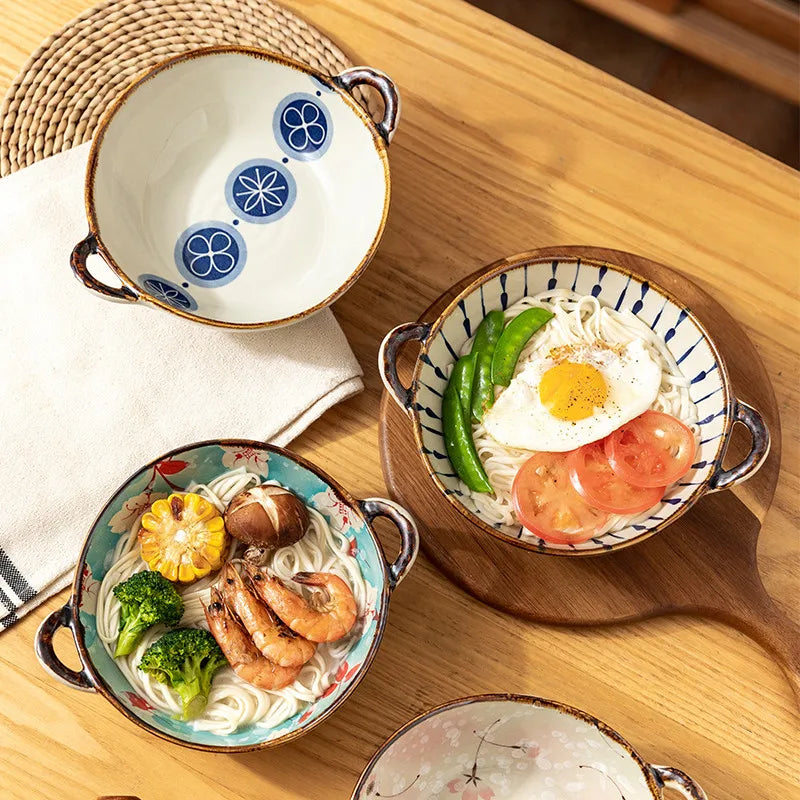 Japanese-style ceramic noodle bowls with two handles in a selection of decorative floral and blue patterned designs.
