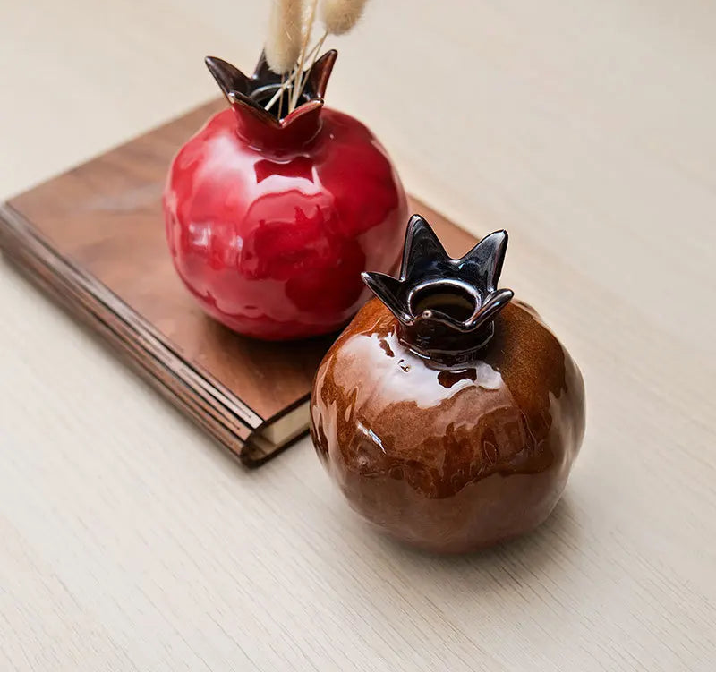 Ceramic pomegranate vase ornament with glossy glazed finish used as decorative tabletop décor
