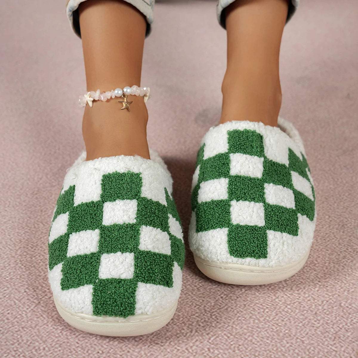 Green and white checkered slippers on a pink background