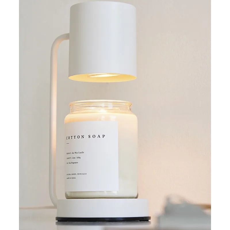 Candle in a glass jar with a white lid on a white background