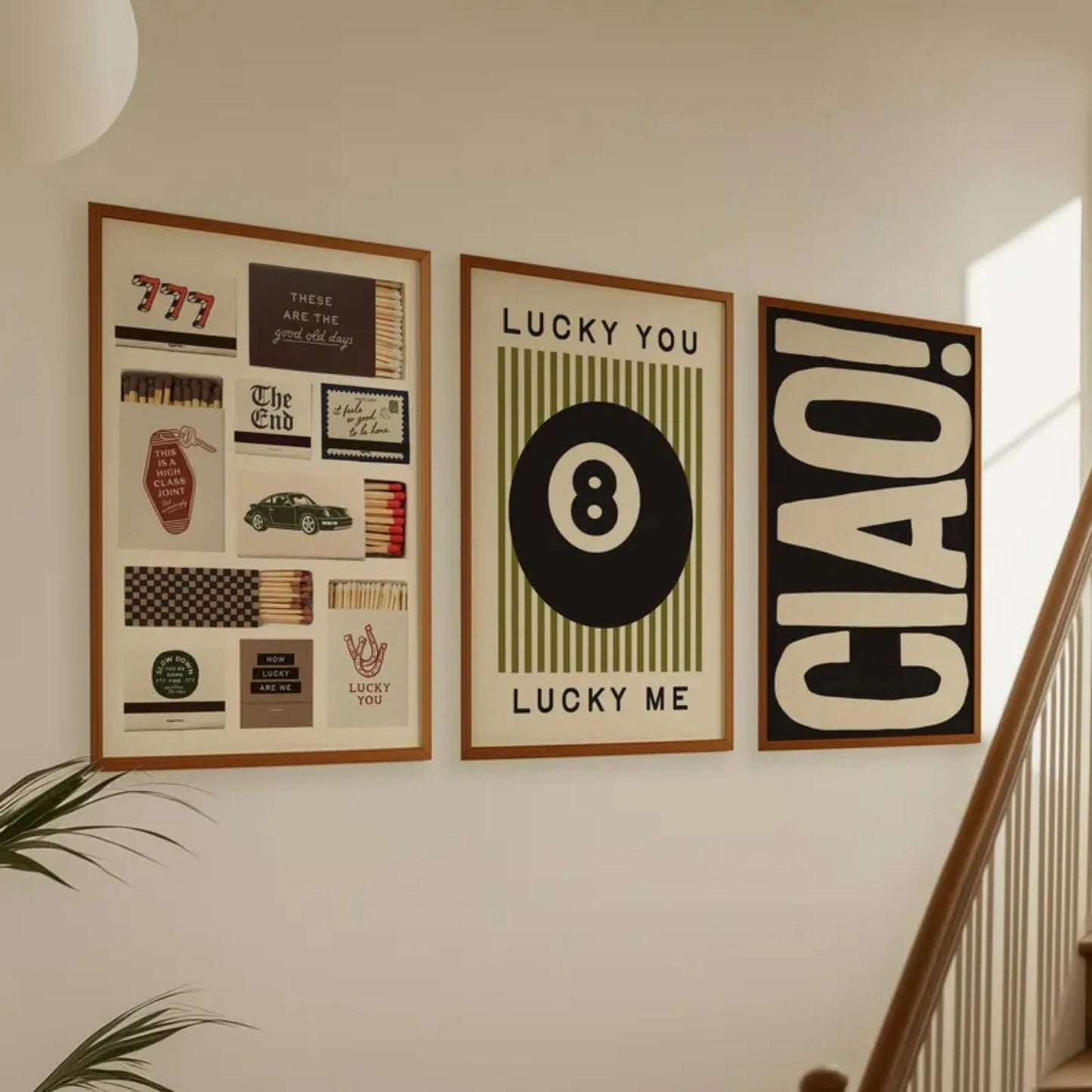 Set of three modern wall art prints featuring 8 ball, typography and graphic design displayed in a living room setting