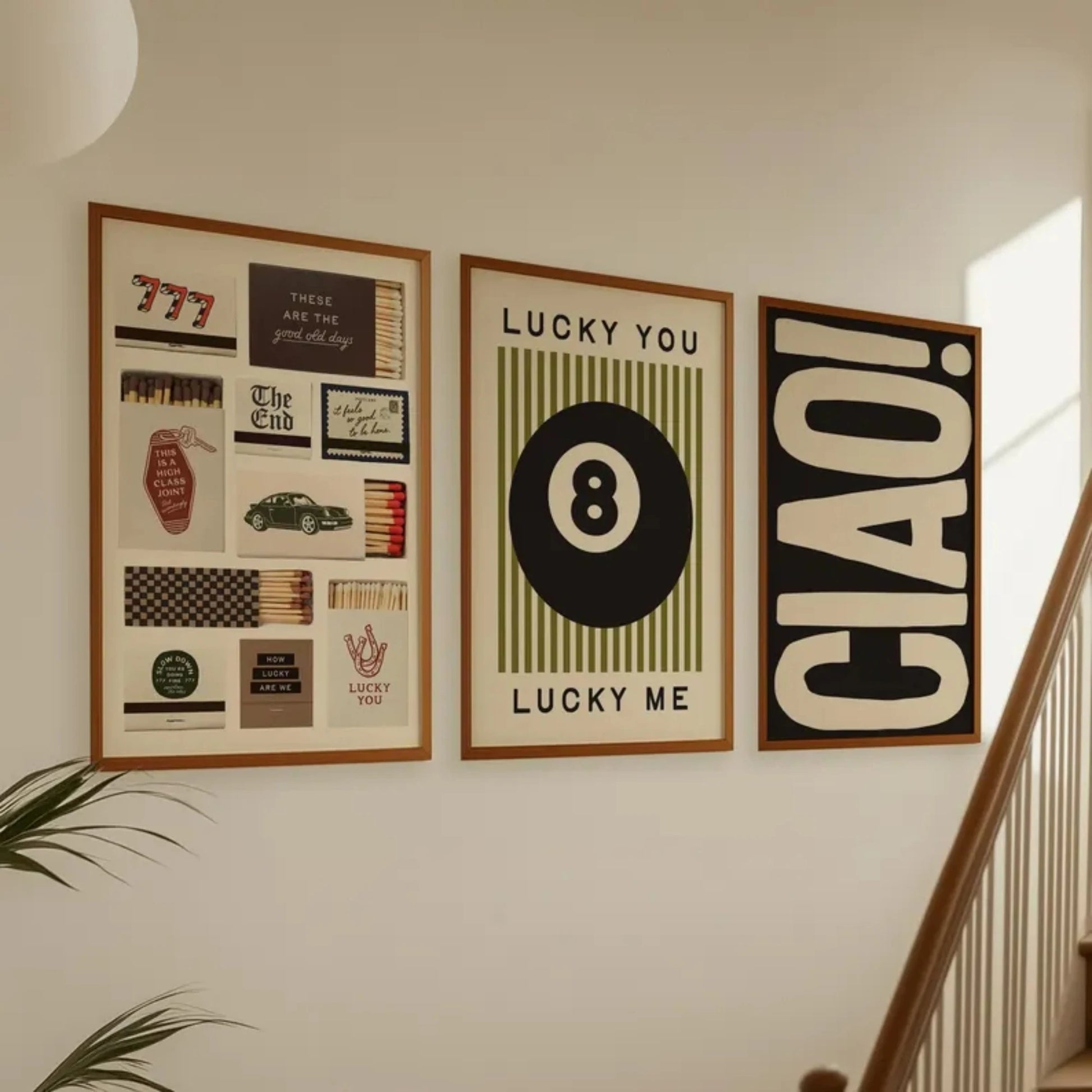 Set of three modern wall art prints featuring 8 ball, typography and graphic design displayed in a living room setting