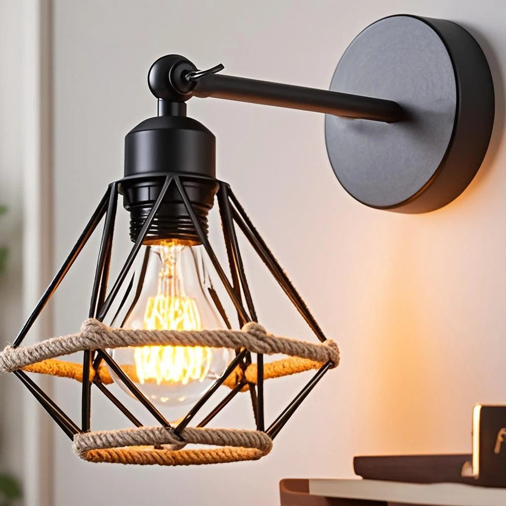 Wall-mounted industrial-style light fixture with a glowing bulb on a neutral background