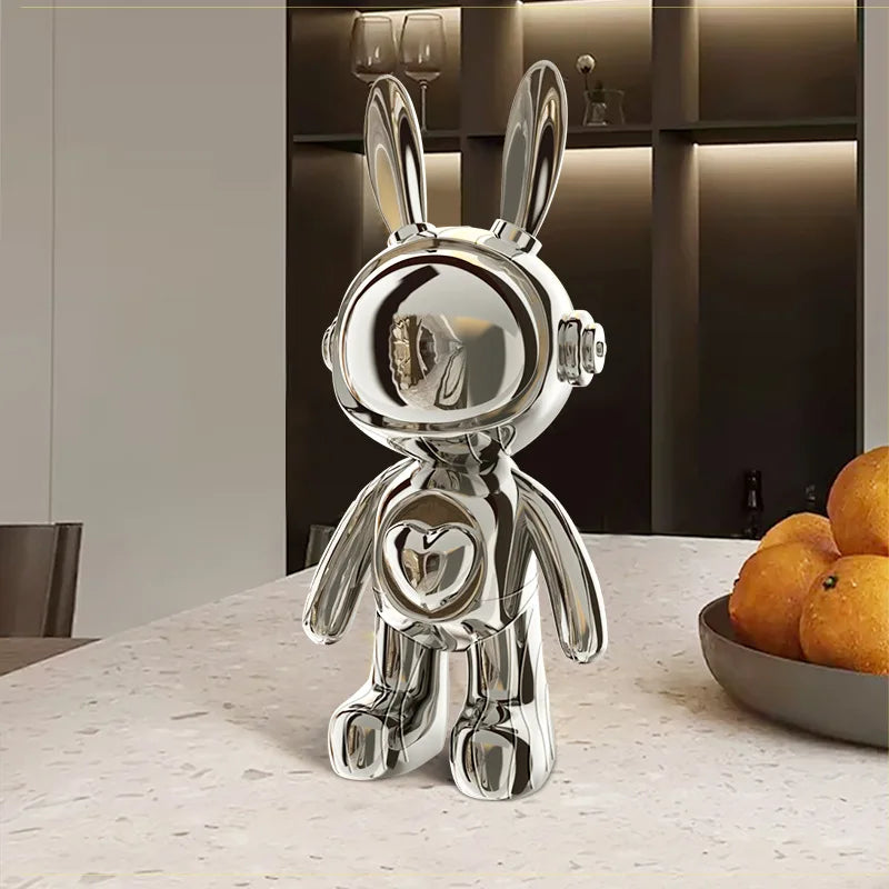 Silver rabbit-shaped decorative object on a table with a blurred background