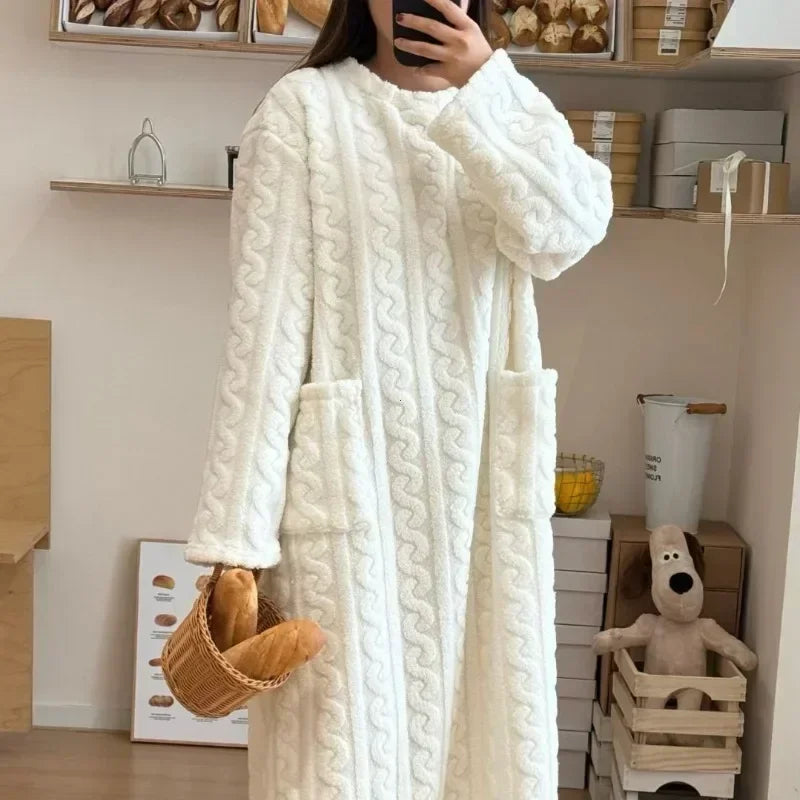 Person wearing a white cable-knit robe in a home setting.