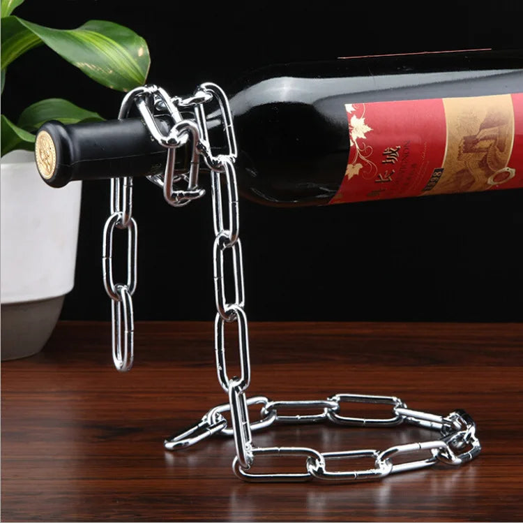 Metal chain bottle holder with a wine bottle on a wooden surface