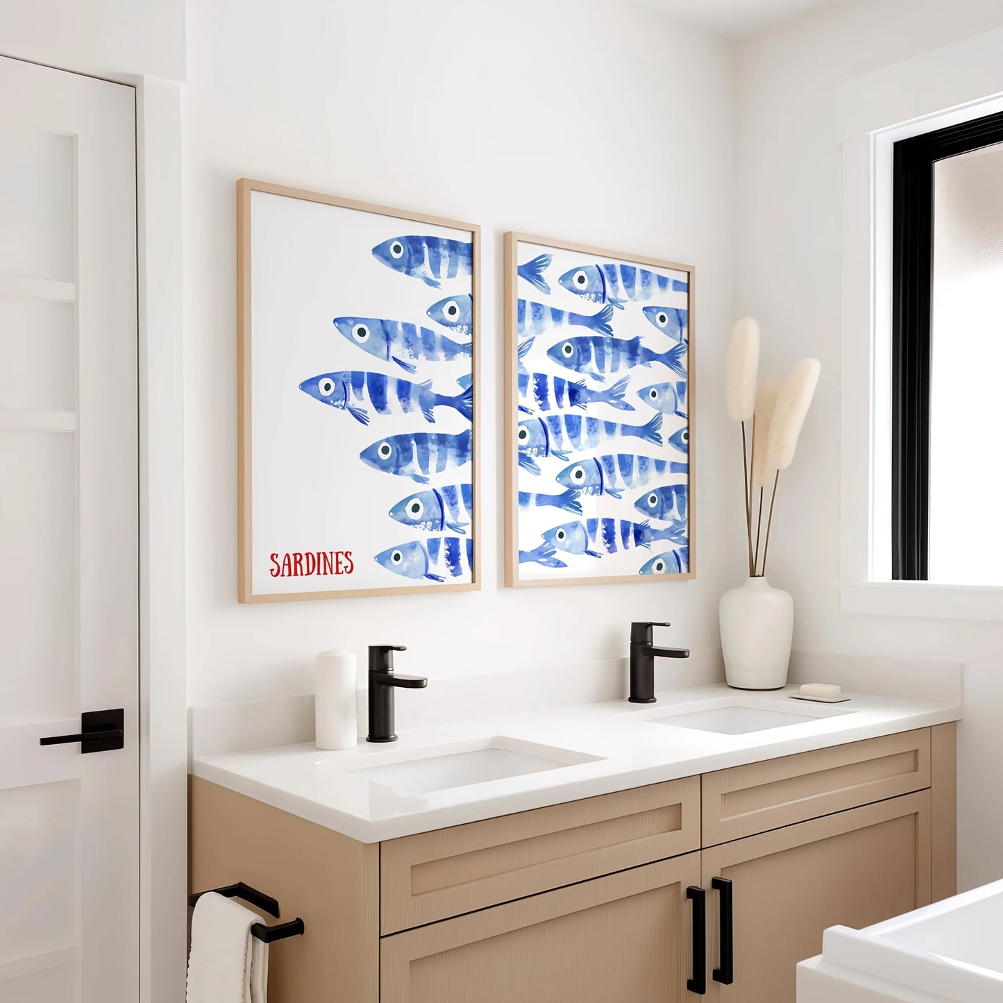 Bathroom with a vanity, sink, and two framed blue fish art prints on the wall.