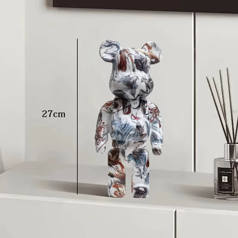 Colorful bear-shaped object on a white surface with a measurement label