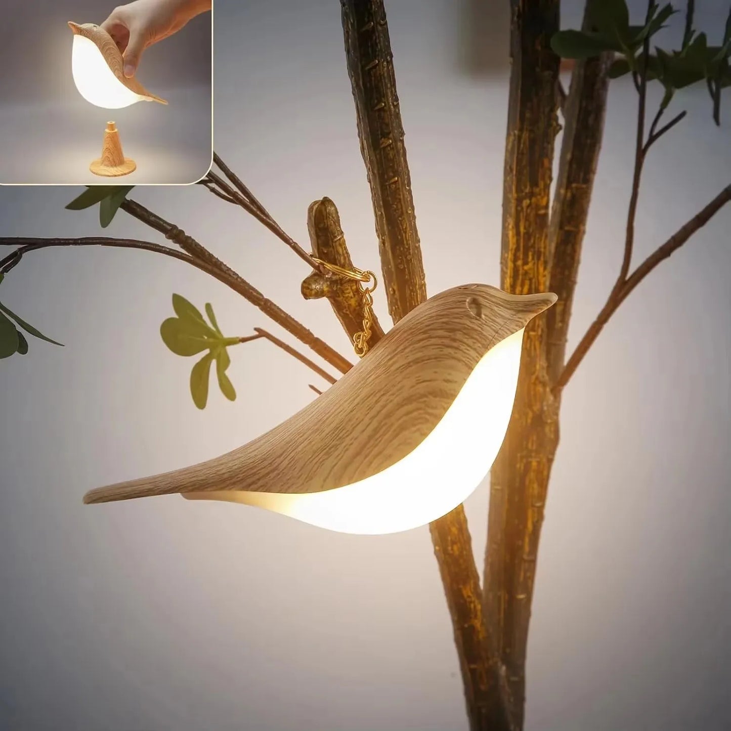 Bird-shaped lamp on a branch with a close-up inset showing the light.