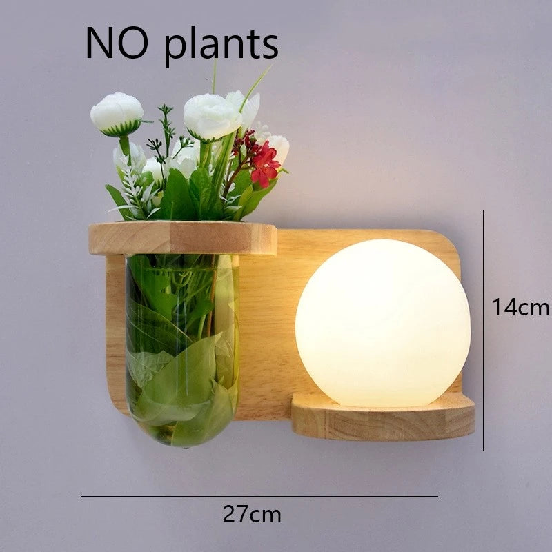 Wooden wall shelf with a vase of flowers and a round light bulb on a gray background