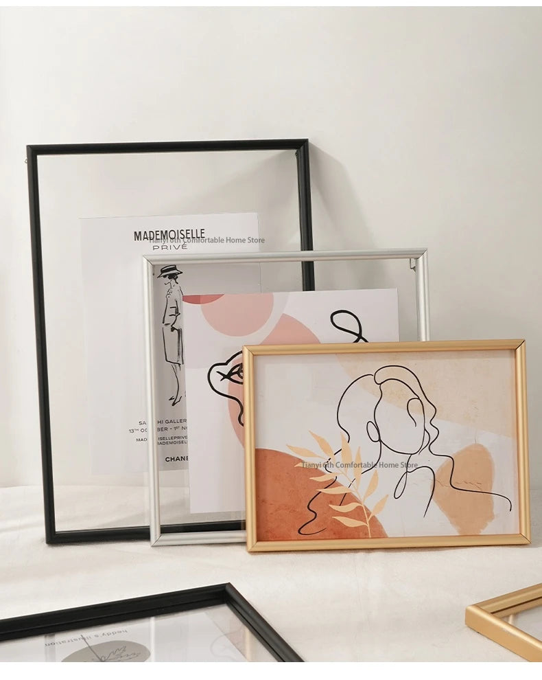 Framed artworks on a white surface with a neutral background