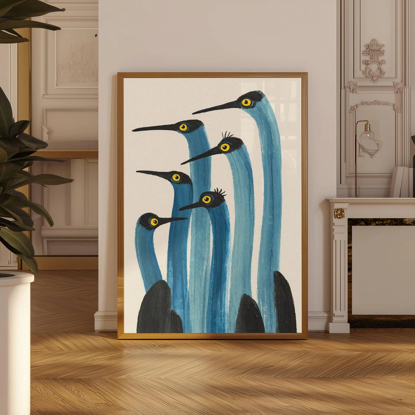 Framed artwork of blue herons in a room with wooden floor and decorative wall.