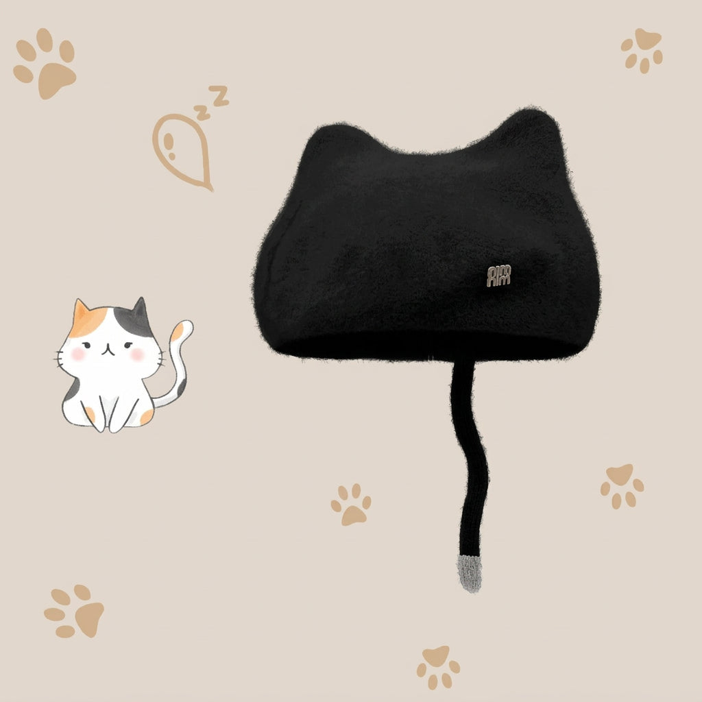 A black cat shapred wool hat with a long tail and gray tip, shown on a beige background with paw prints and a small cat illustration. 