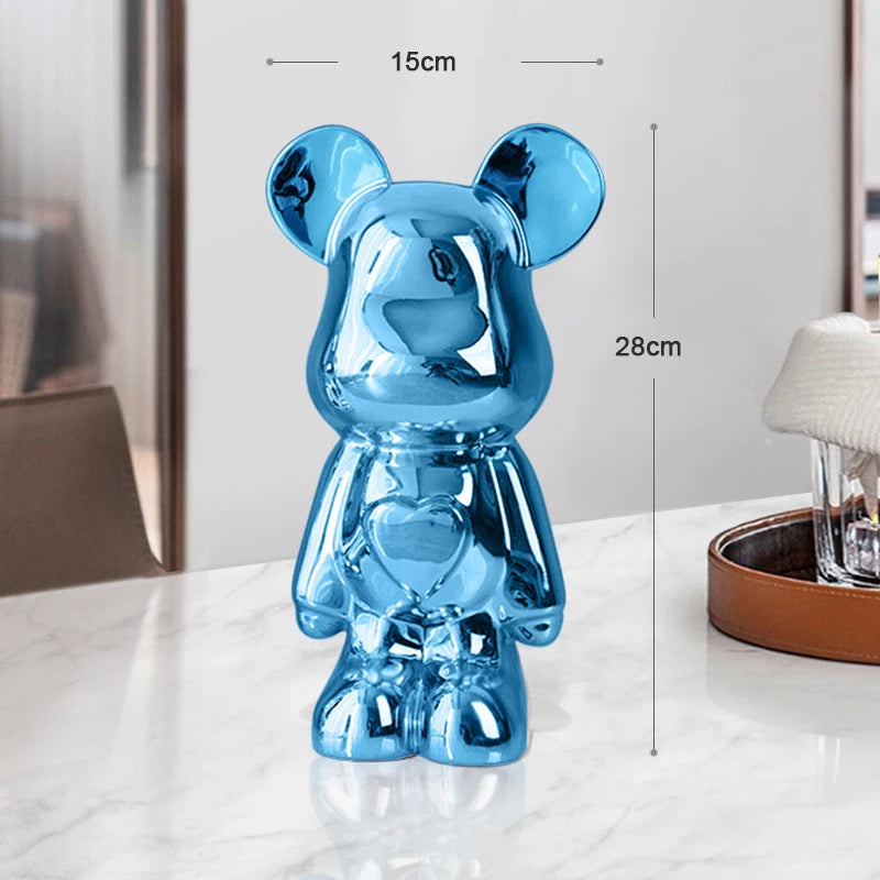 Blue glass bear figurine with measurements on a white surface