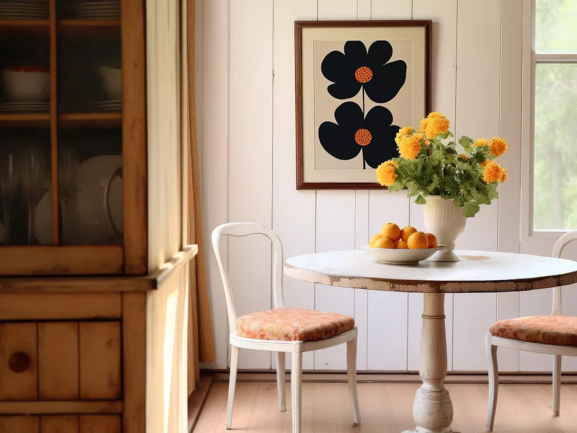 Dining room with wooden cabinet, round table, chairs, and floral arrangement.