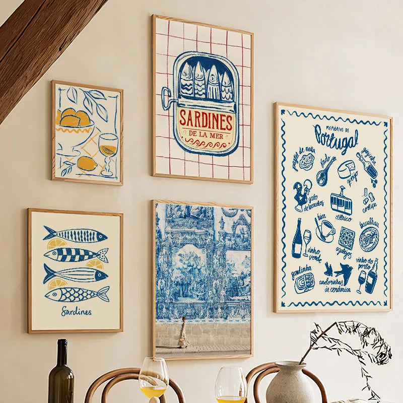 Set of framed artworks on a wall above a dining table.