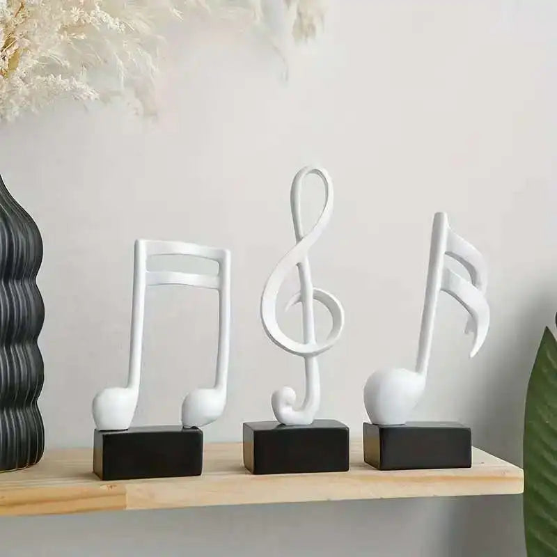 Set of three modern resin musical note sculptures with black bases displayed as contemporary home décor, available in black, white and gold finishes.