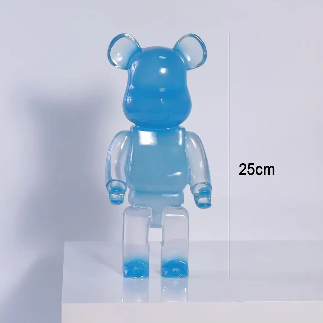 A translucent light blue bear-shaped collectible figure standing on a white platform against a light gray background, with a vertical measurement line and text reading 25cm indicating height.
