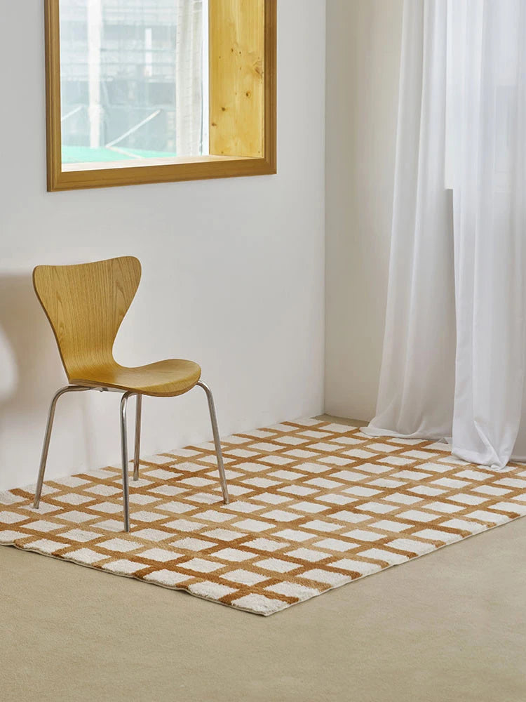 Wooden chair on a checkered rug in a room with a window and white curtains.