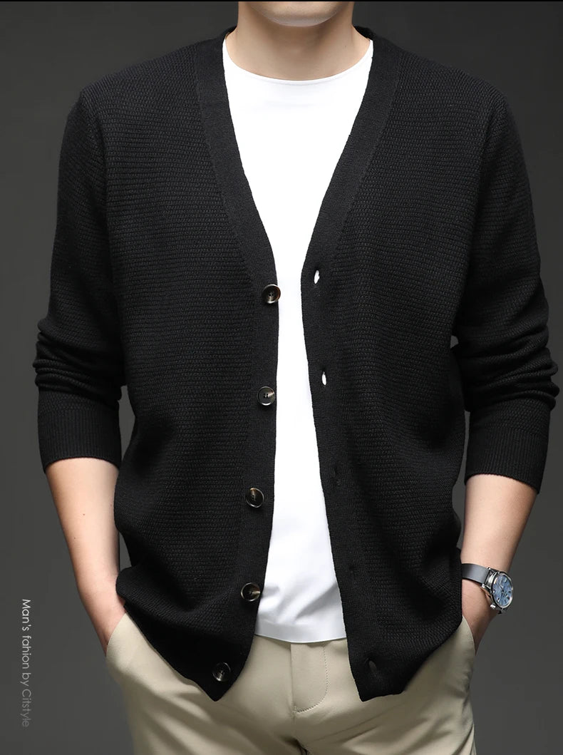 Black cardigan open view and worn by a person on a dark background 