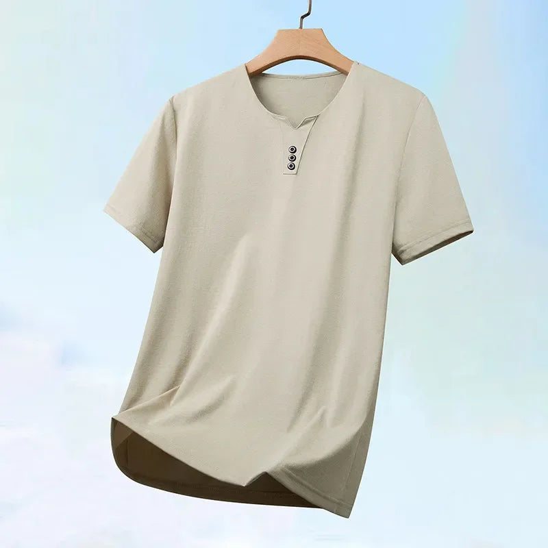 Beige t-shirt on a wooden hanger against a light blue gradient background