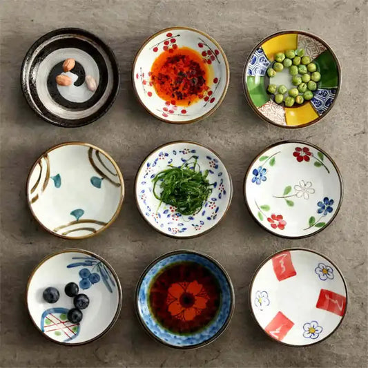 Small round Japanese style ceramic sauce dishes with assorted glazed patterns arranged on a table