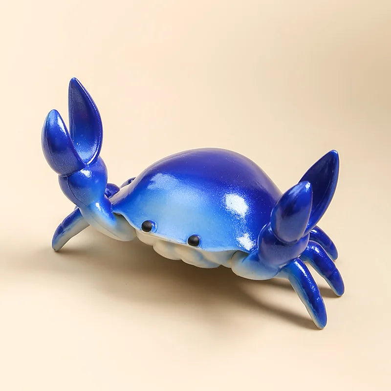 Blue crab-shaped desktop organiser on a beige background