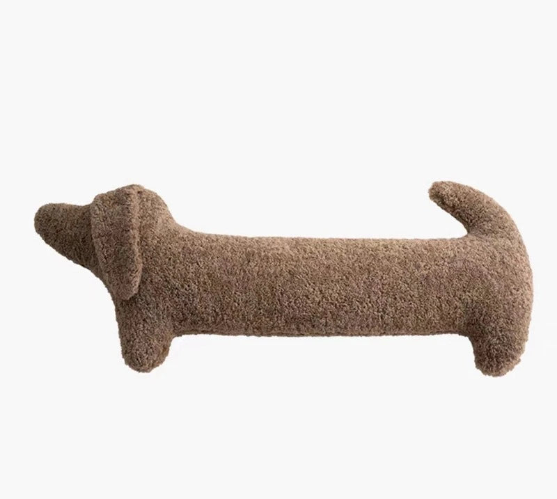 Brown dog-shaped cushion on a white background