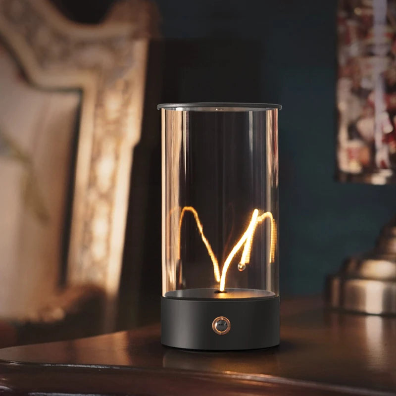 Modern table lamp with a glass shade and black base on a wooden surface.