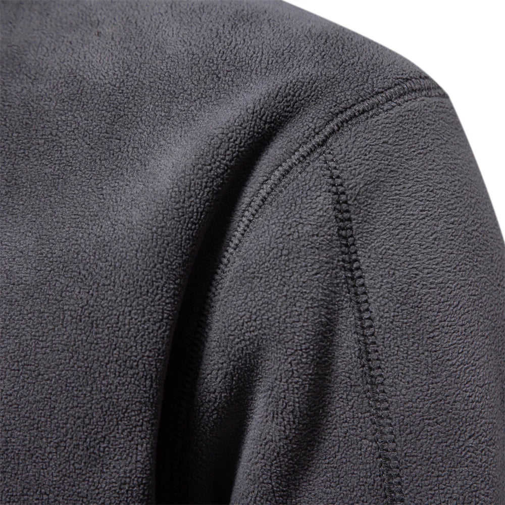 Close-up of a textured gray fleece jacket sleeve