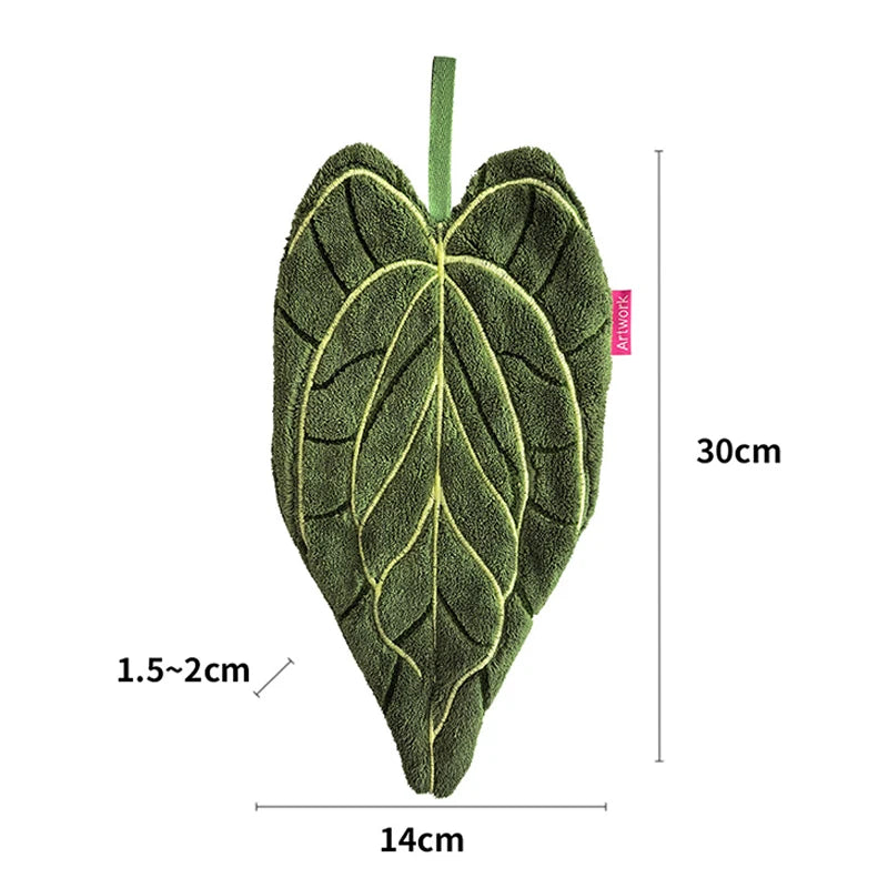 Green leaf-shaped decorative towel with measurements on a white background