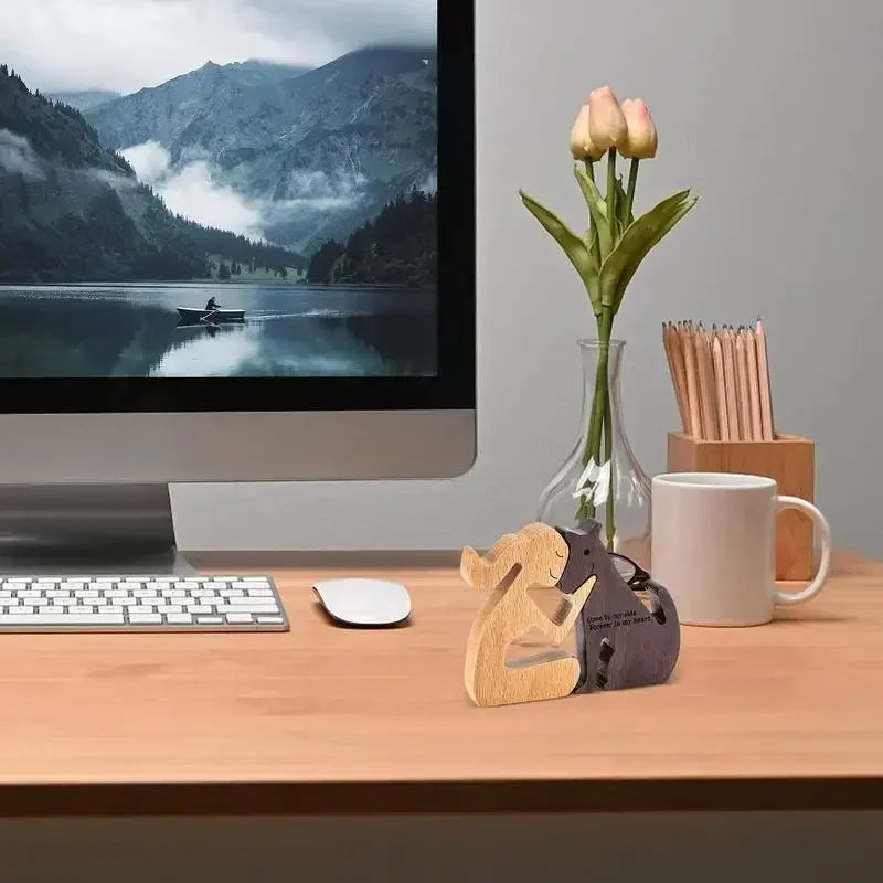 Desk setup with computer, mug, and decorative items on a wooden surface.