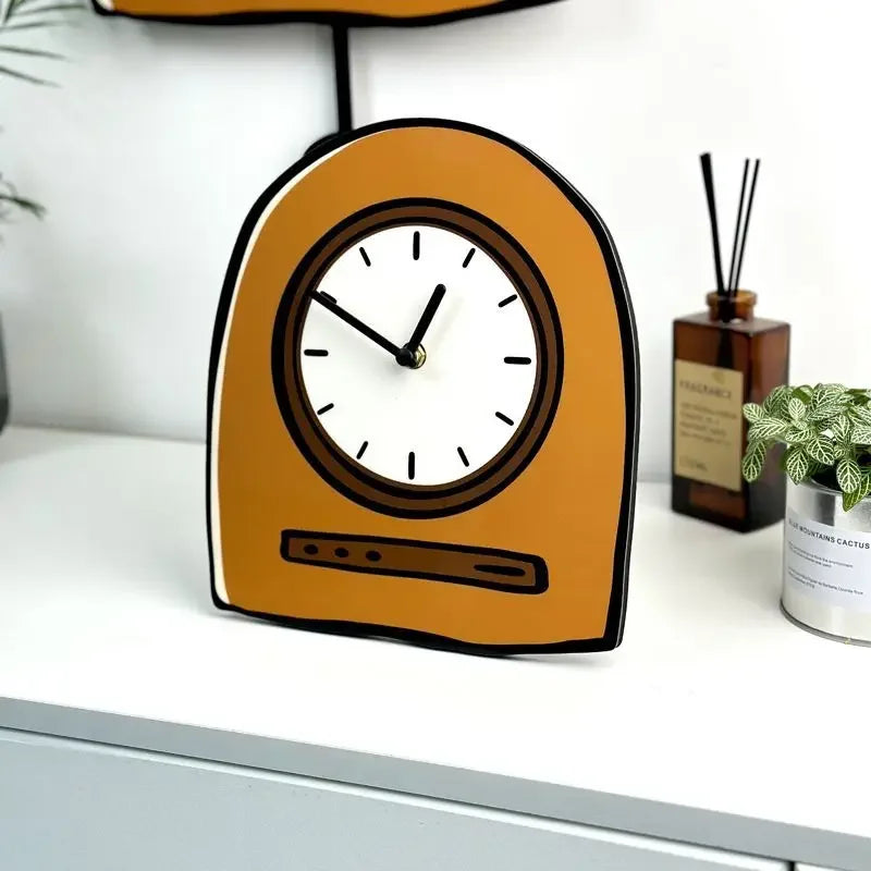 Orange clock on a white surface with a plant and bottle in the background