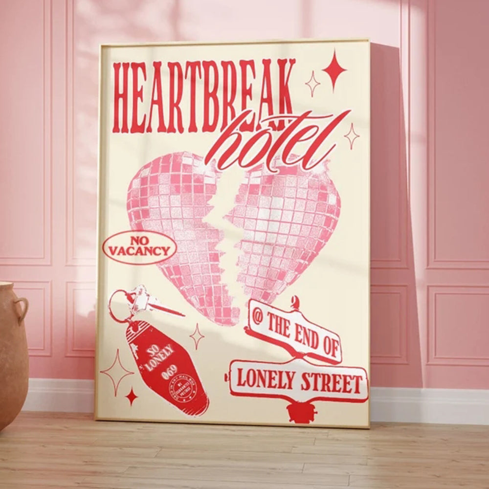 Decorative sign for 'Heartbreak Hotel' with a pink heart design on a wall.