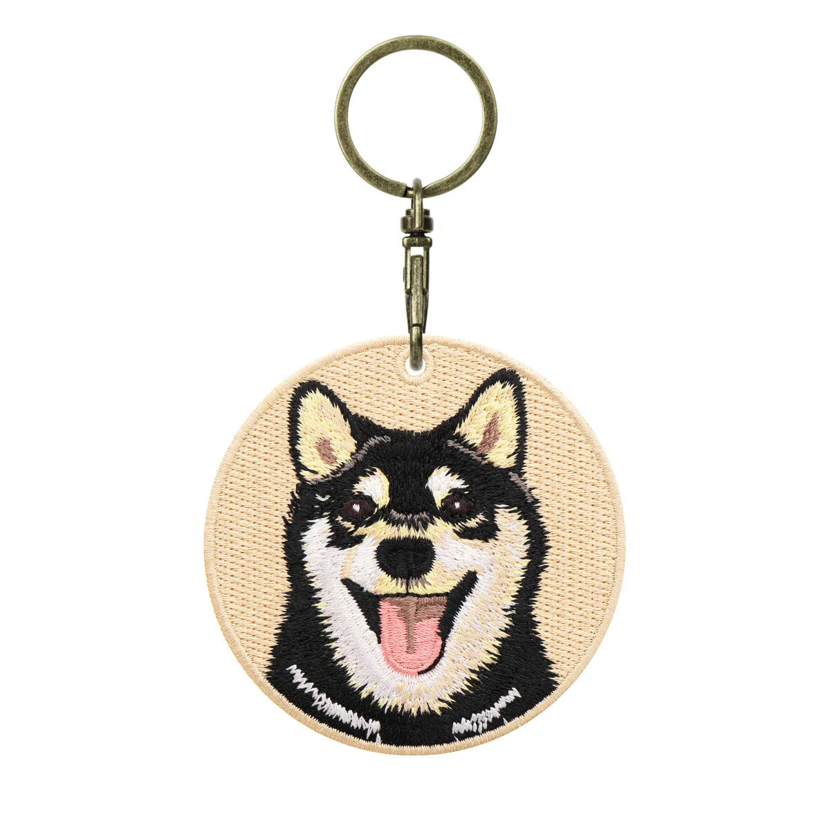 Keychain with embroidered dog design on a white background