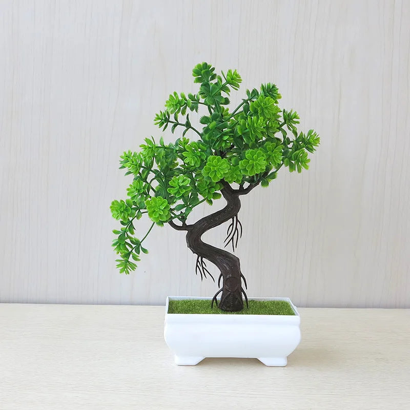 Artificial bonsai tree in a white pot on a light gray background