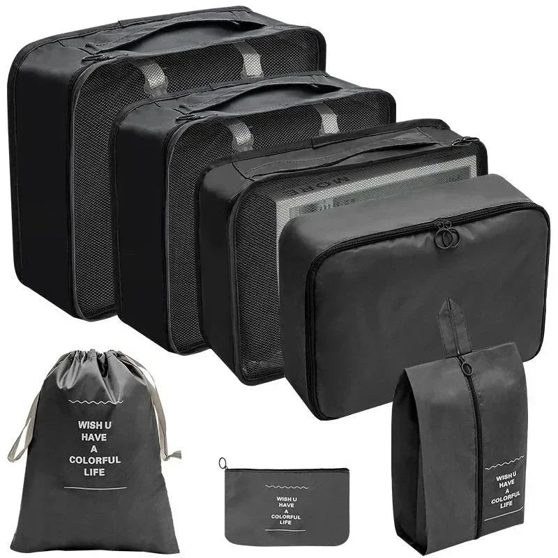 Set of black packing cubes and bags with motivational text on a white background