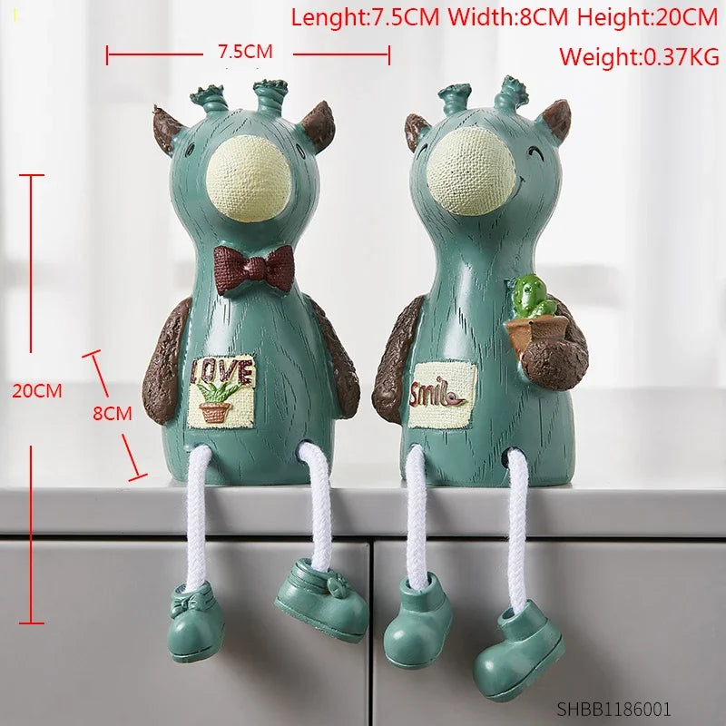 Two green monster-shaped hooks with measurements and text on a white background