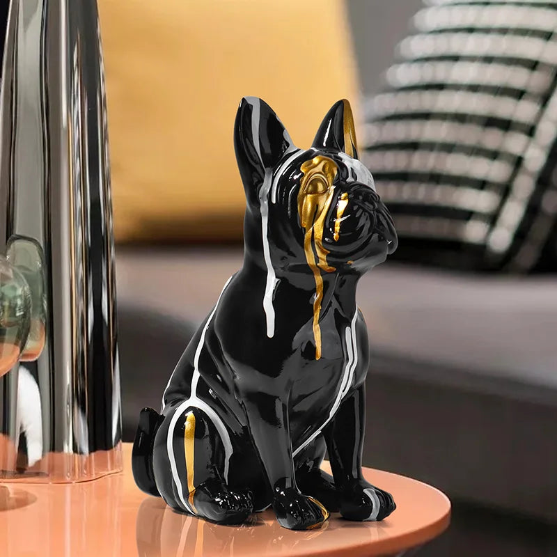 Black and gold ceramic dog figurine on a table with a blurred background