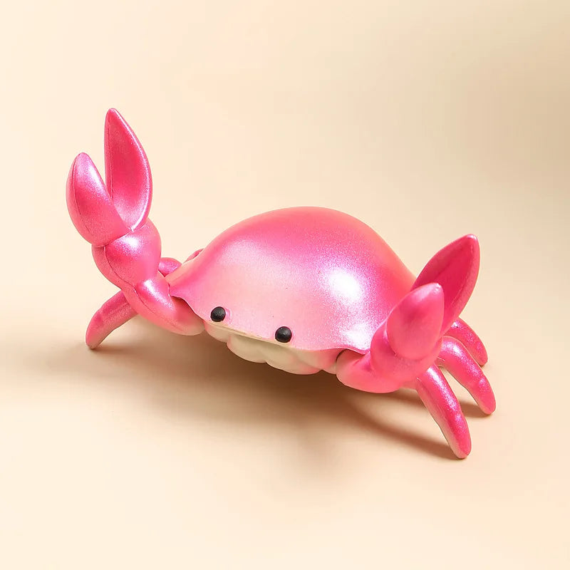 Pink crab-shaped desktop organiser on a beige background