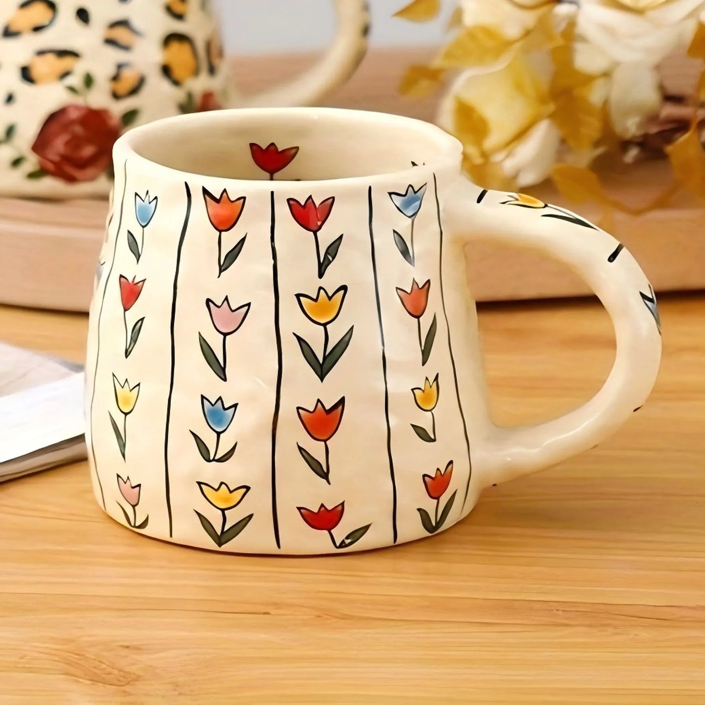 White mug with colorful floral patterns on a wooden surface
