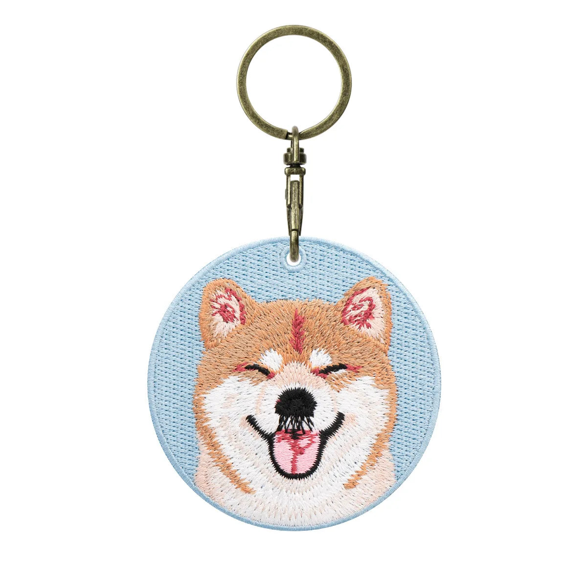 Embroidered keychain with a dog design on a light blue background