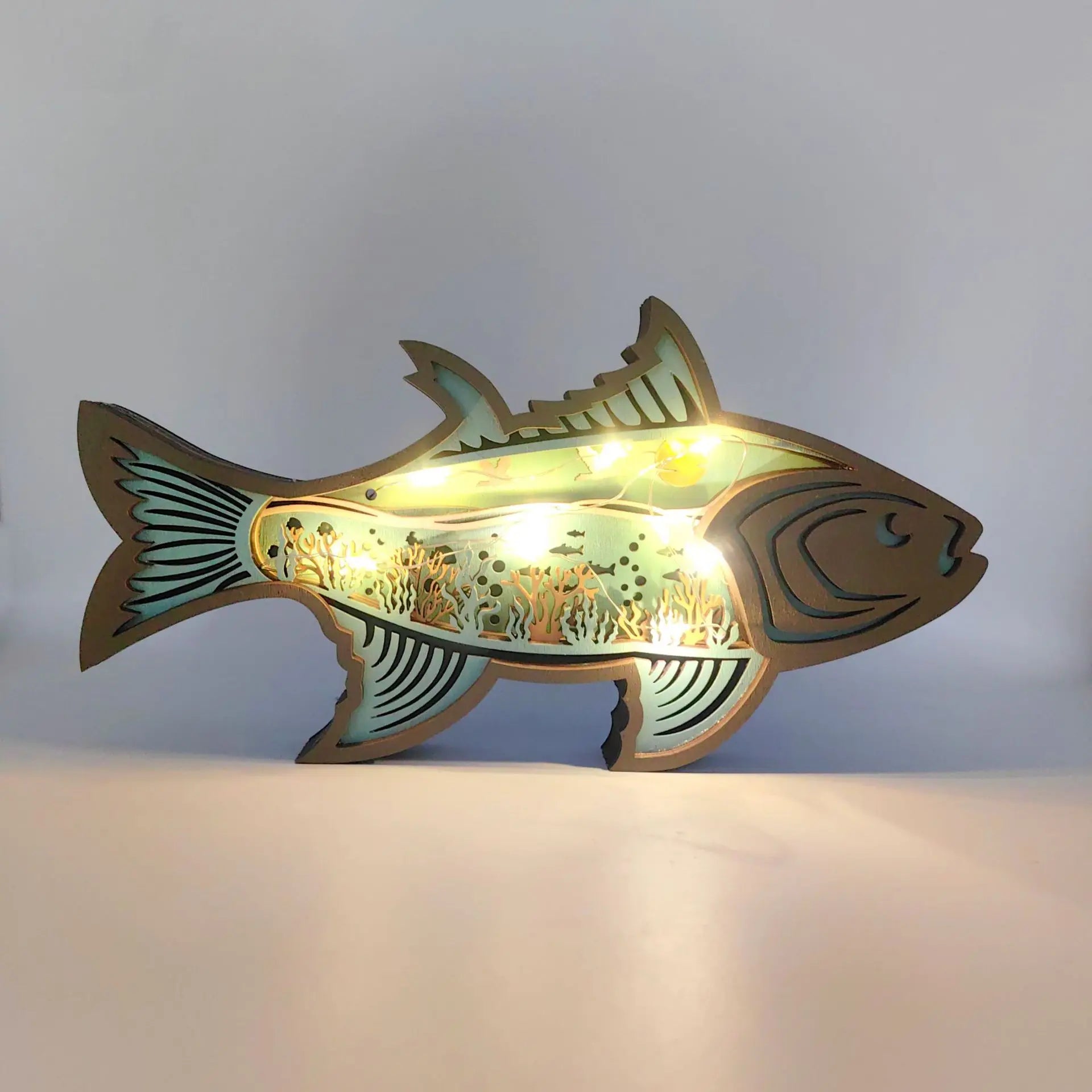 Fish-shaped lamp with a light on a gray background